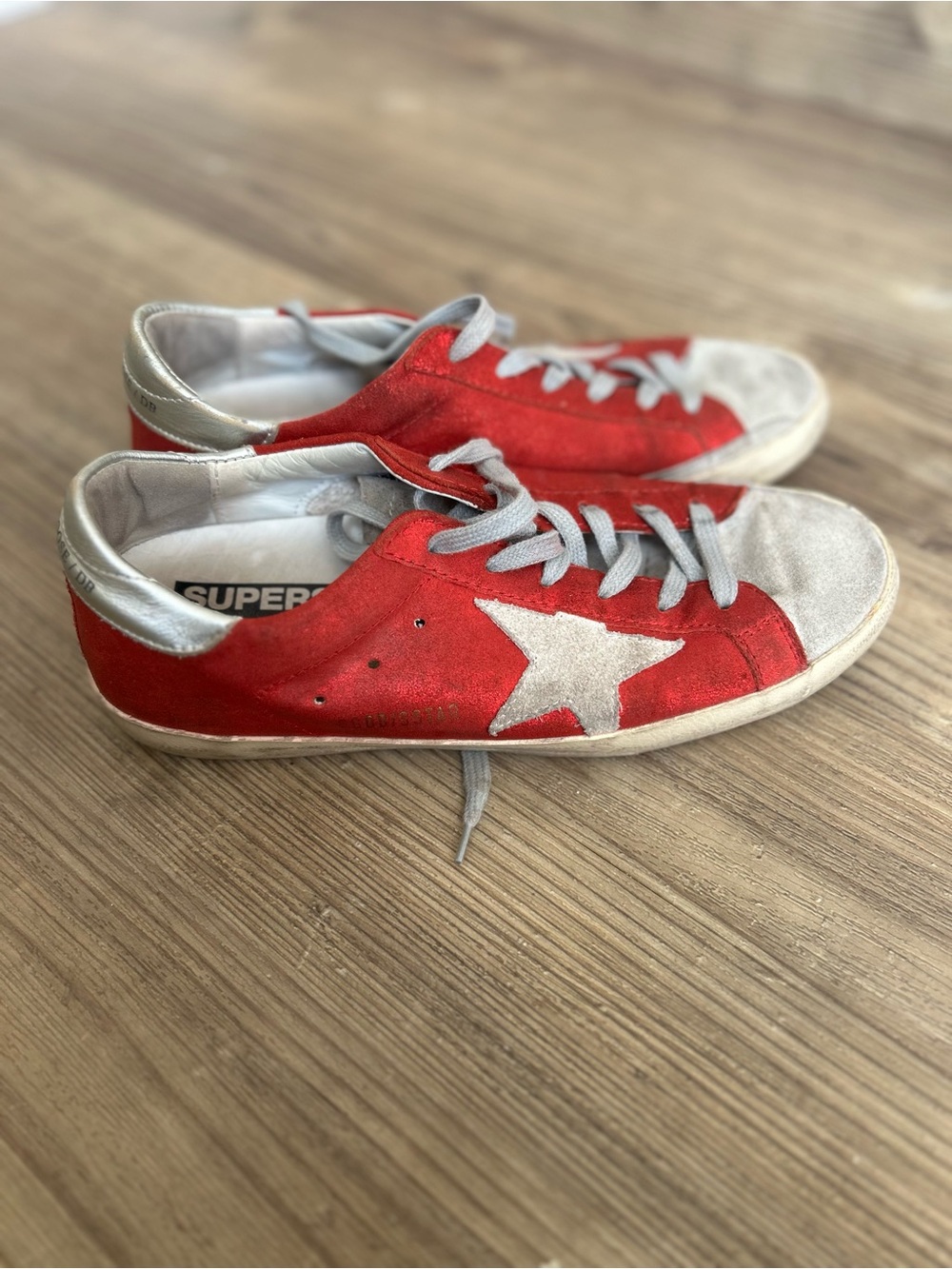 Golden Goose Superstar red glitter sneakers signature white leather star detail.